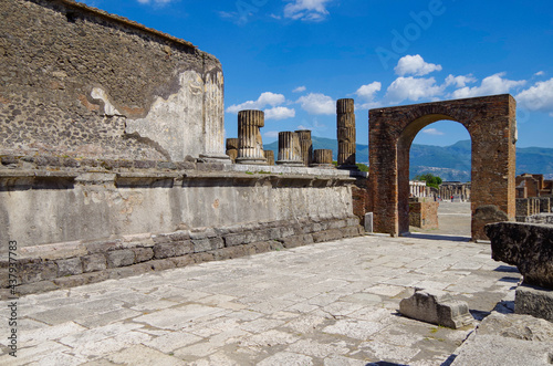 Famous landmark of ancient and historic city temple ruins with columns and walls on archeologic site museum Pompeji Pompeii excavation site in Italy near Naples and Vesuv Volcano photo