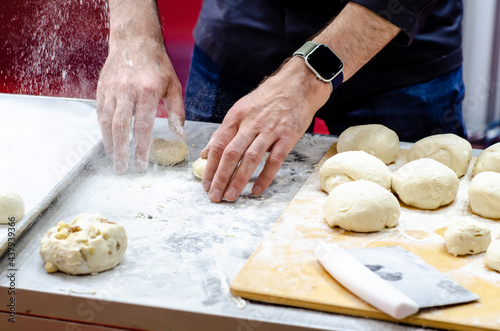 Chief baker prepares bun dough