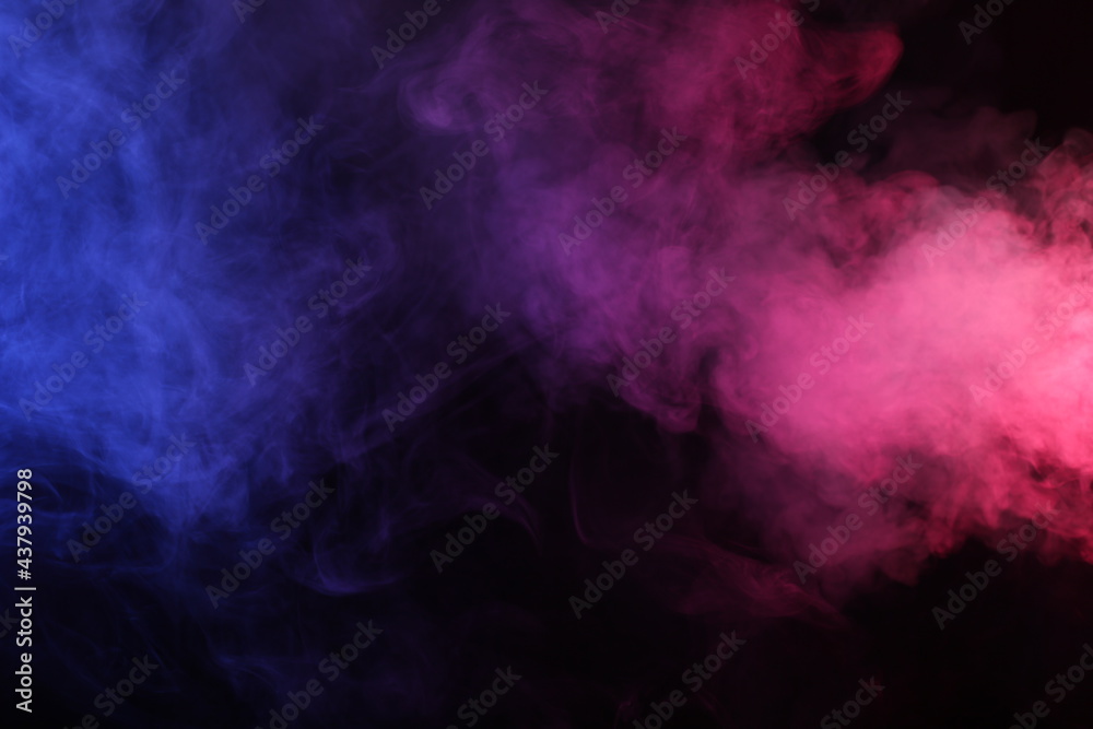 Artifiacial magic smoke in red-blue light on black background