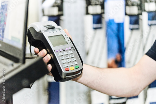 Salesman holds a contactless payment terminal in his hand