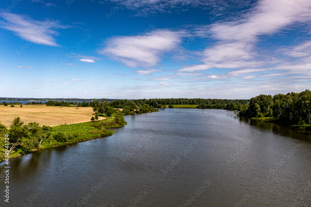 panoramic view from the drone to the village of a large lake and forest and fields and roads 
