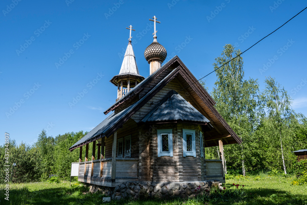old stone building with a chapel and a church against the blue sky old stone building with a chapel and a church against the blue sky