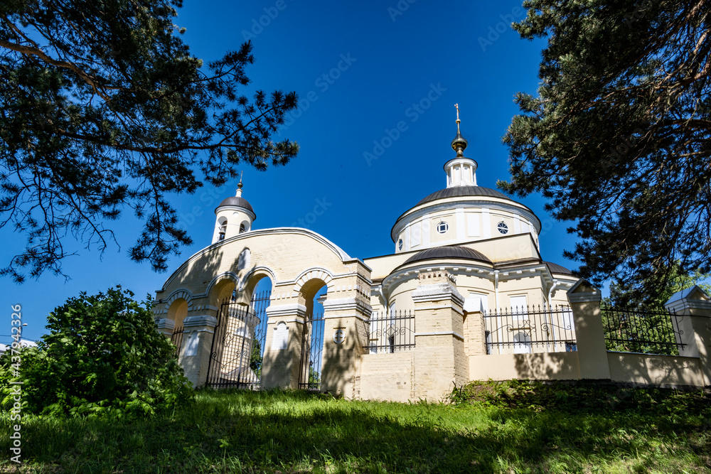 old stone building with a chapel and a church against the blue sky old stone building with a chapel and a church against the blue sky