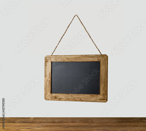 Blackboard hold by string over a table
