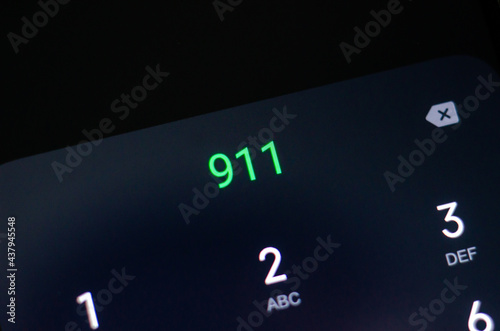 Emergency number 911 displayed on a cell phone.