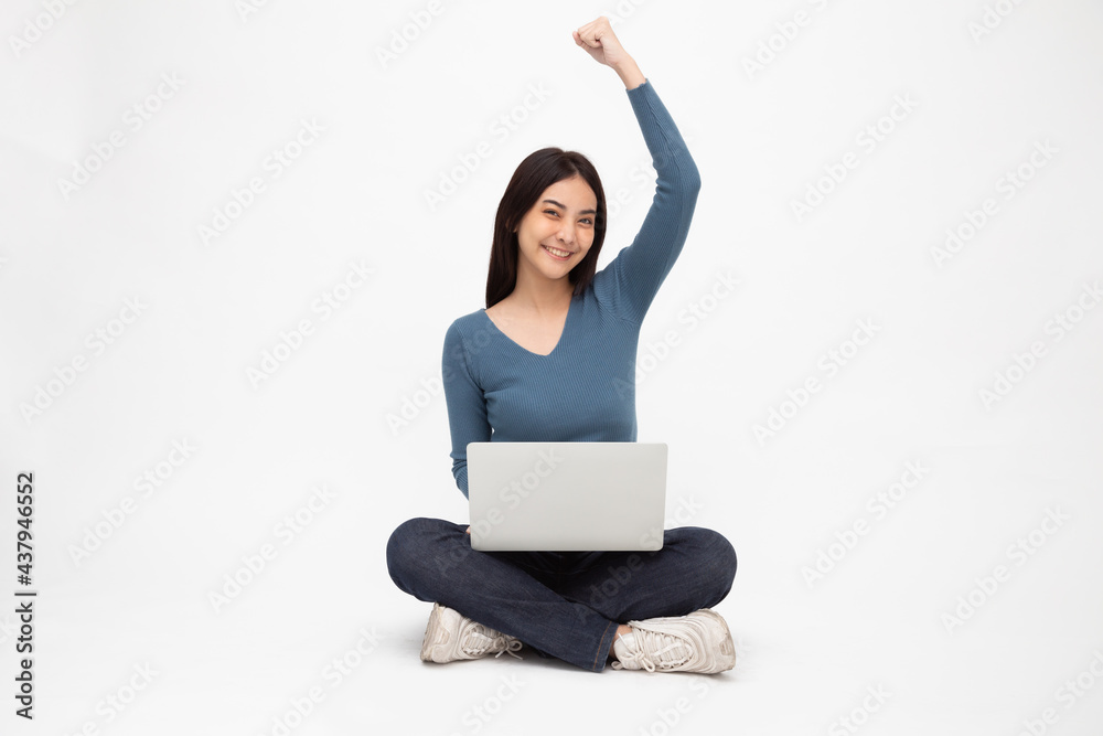 Happy young Asian woman sitting on the floor with crossed legs and rasing hand up and using laptop computer isolated on white background, Full body Happy young Asian woman sitting on the floor with crossed legs and rasing hand up and using laptop computer isolated on white background, Full body