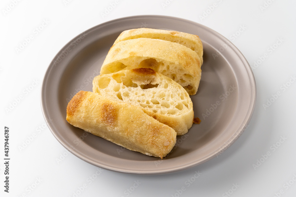 Freshly baked ciabatta bread is placed on a plate