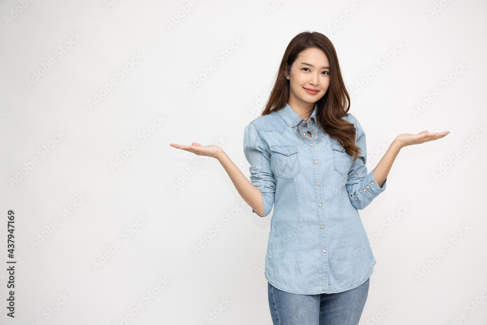 Happy Asian woman wearing jeans shirt and presenting, showing open hand palm with copy space for product isolated on white background Happy Asian woman wearing jeans shirt and presenting, showing open hand palm with copy space for product isolated on white background