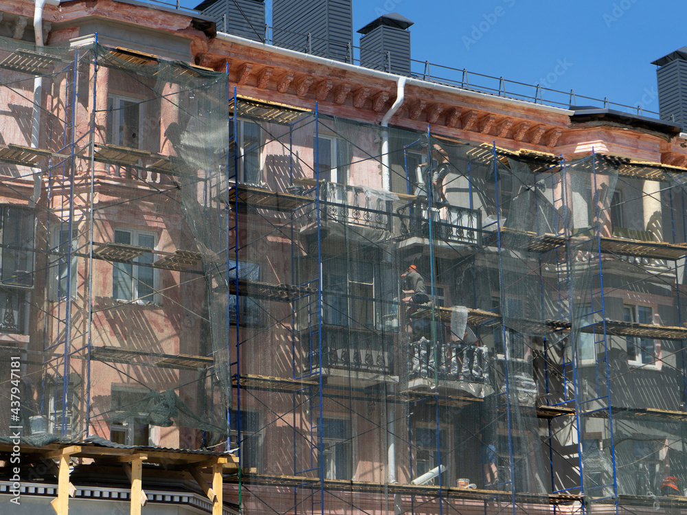 Fototapeta premium Scaffolding around a building, renovating facade building.