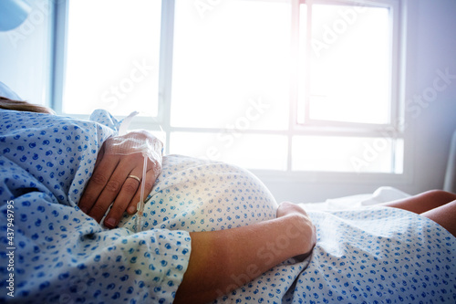 Close-up of a pregnant woman's belly in hospital photo