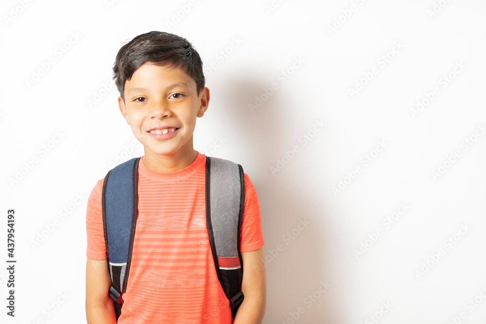 Smiling and excited child holding his school bag ready for the start of school. Back to school concept Smiling and excited child holding his school bag ready for the start of school. Back to school concept