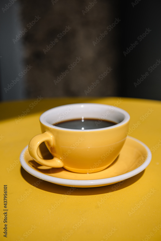 cup of coffee on yellow table. summer terrace cup of coffee on yellow table. summer terrace