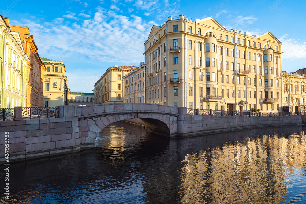 Canals of Saint Petersburg. Architecture of Russia. Bridge over the canal in Saint Petersburg. Winter bridge on a summer day. Panorama of Saint Petersburg with a bridge. Guide to Russia.
