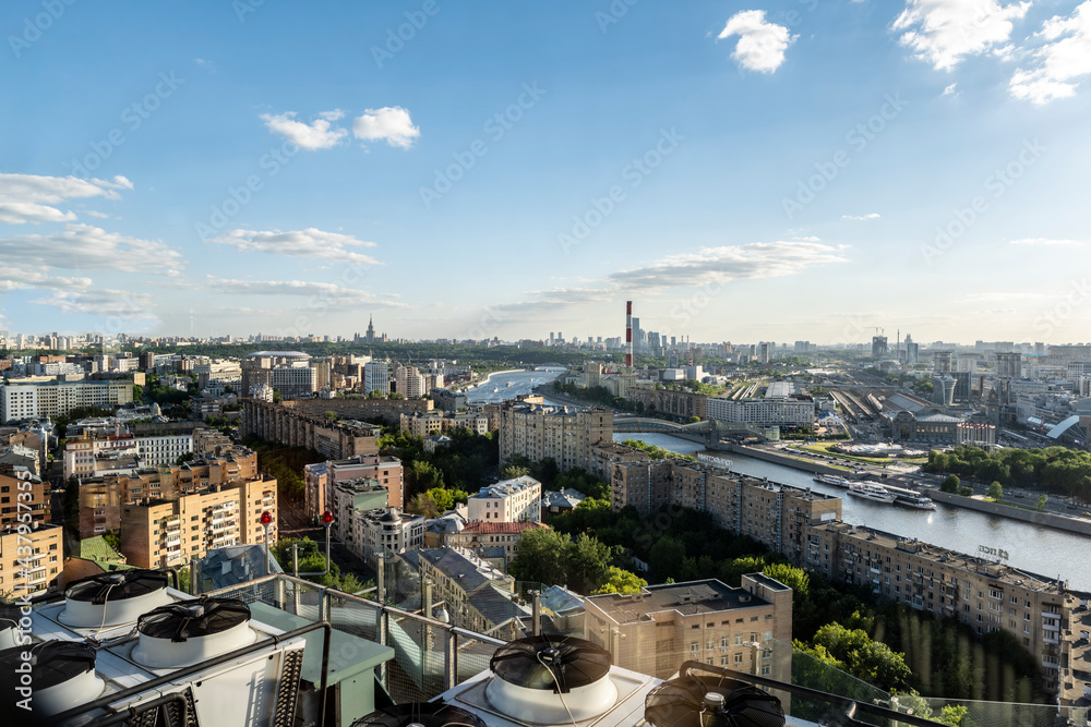 panoramic view of the city from the window of a high-rise building on a sunny evening 