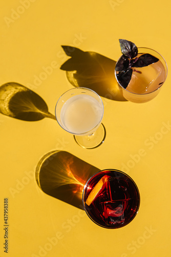 refreshment cocktails on the yellow table. top view with shadows