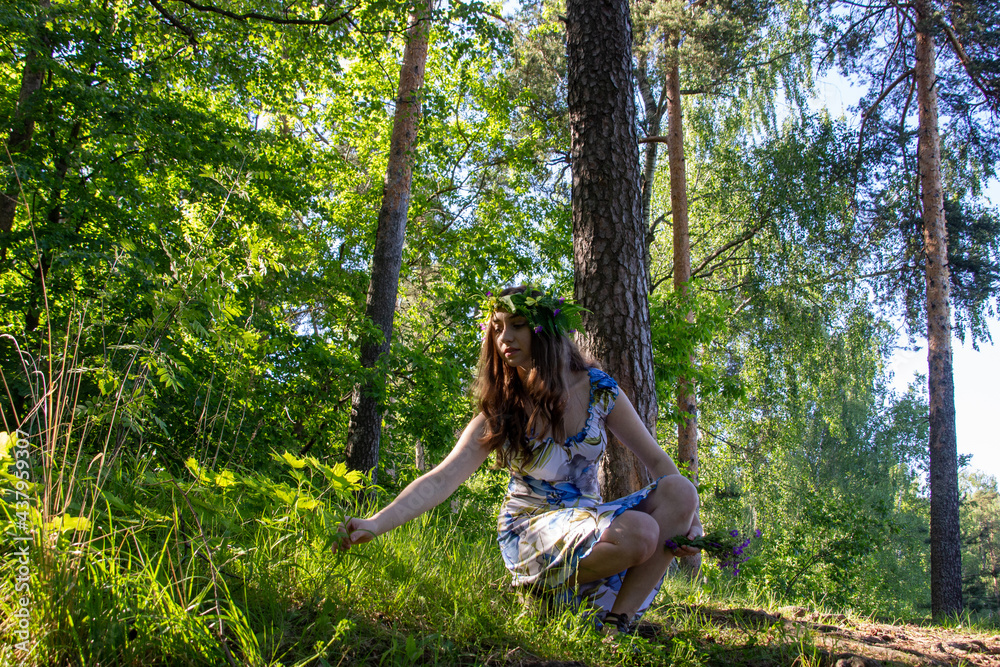 Naklejka premium Beautiful blue eye girl in floral crown and dress in the sunnt sumer forest on river side