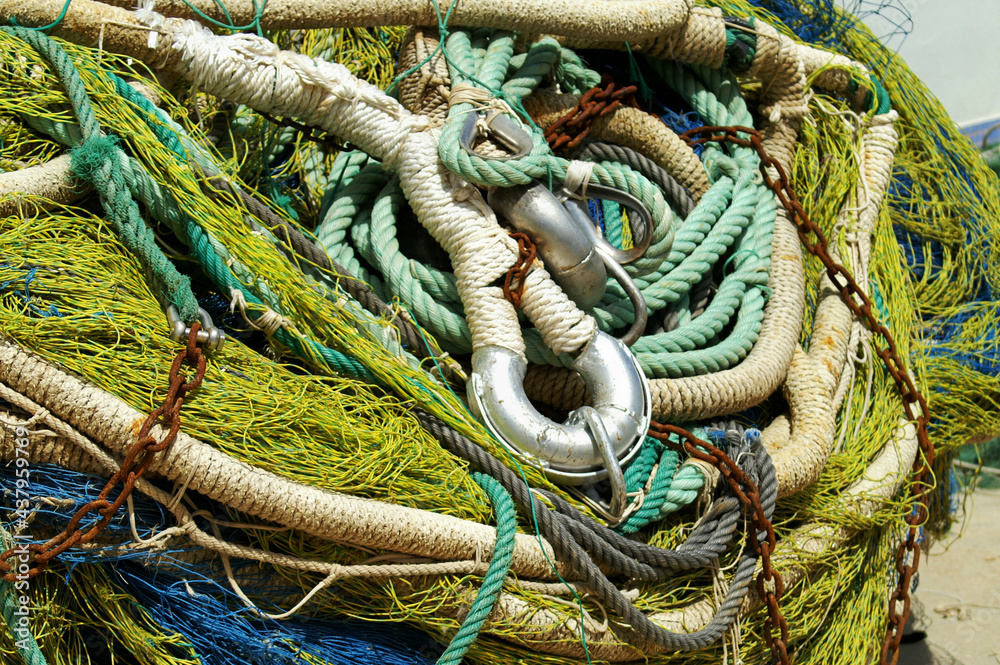 Fishing tackle waiting in the harbour with fishnet and coluor ropes
