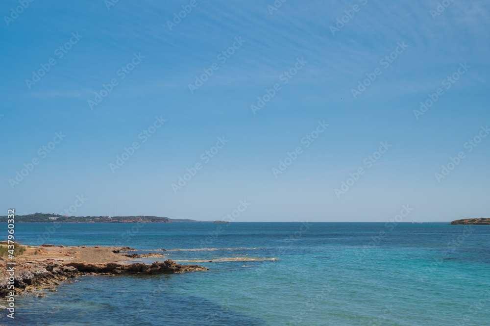 Scenic landscape of Aegean sea at sunny summer day. Athens, Greece. Stone shore. Blue sky and water.