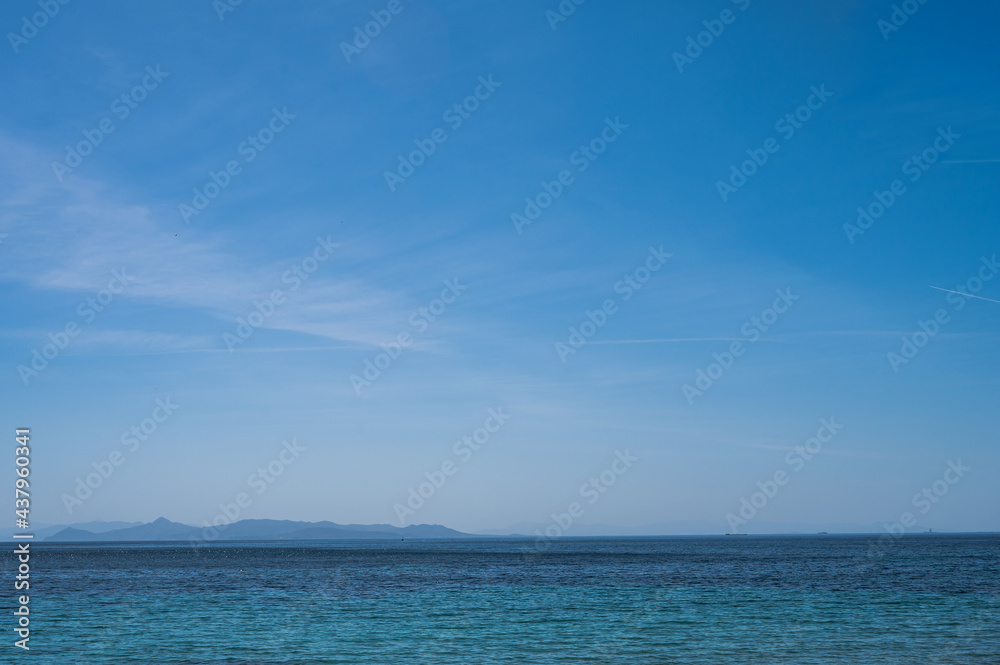 Scenic landscape of Aegean sea at sunny summer day. Athens, Greece. Silhouettes of islands in mist.