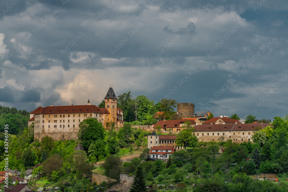 Castle on big hill in Vimperk town in spring sunny and cloudy day