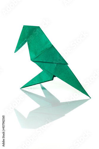Origami bird made of colored paper isolated on white background