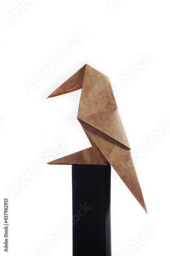 Origami bird made of colored paper isolated on white background