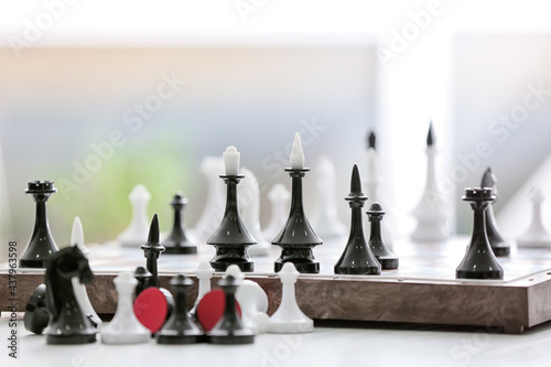 Board with chess pieces on table