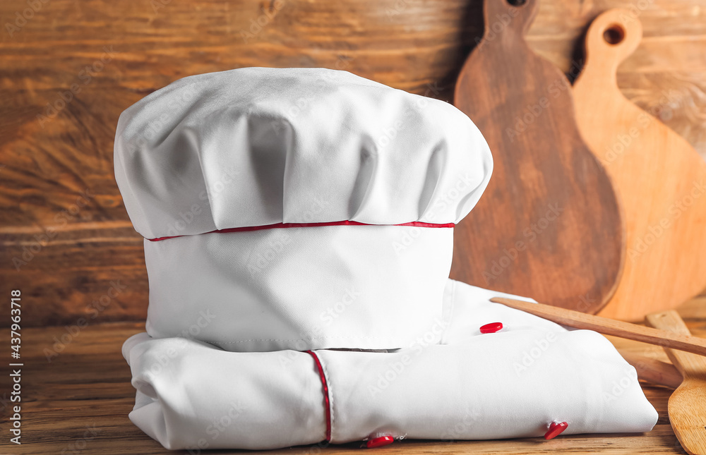 Chef’s uniform on wooden background Stock Photo | Adobe Stock
