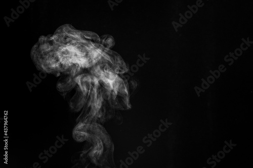 Smoke fragments on a black background. Abstract background, design element, for overlay on pictures © Alena