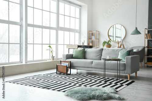 Stylish interior of living room with comfortable sofa photo