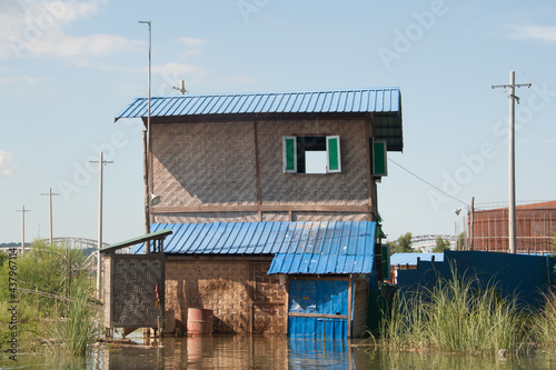 Wood and brick house in peril of flooding in Myanmar