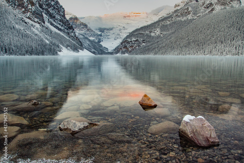 Lake Louise British Columbia at sunrise during the winter with fresh snow on the surrounding mountains