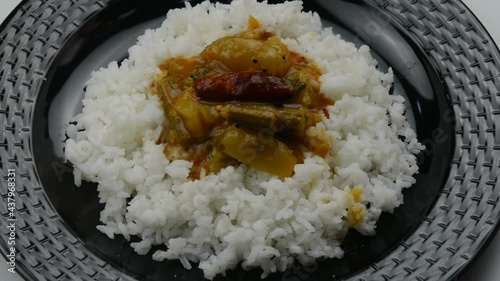 Serving sambar with white rice in a plate. photo