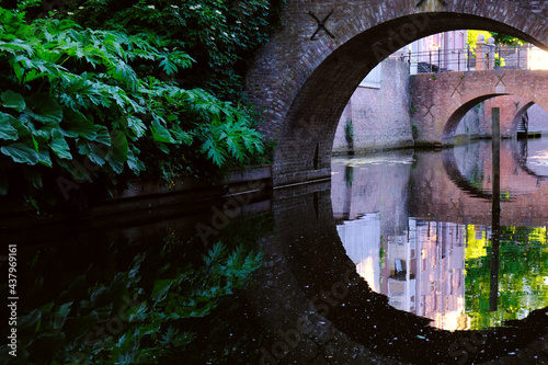 Old stone bridge over water with reflection