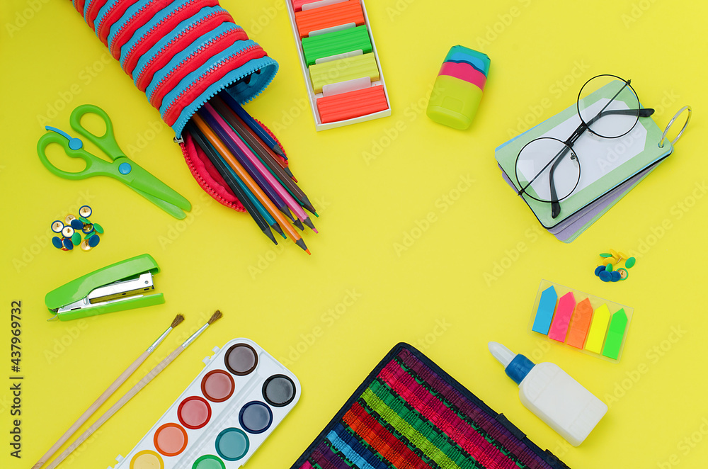 Back to school. School supplies: scissors, stationery buttons, stapler, brushes, paints, notebook, glue, grater, glasses,Rubik's cube, notebook,pencil case, bookmarks, pencils,plasticine.Bright colors Back to school. School supplies: scissors, stationery buttons, stapler, brushes, paints, notebook, glue, grater, glasses,Rubik's cube, notebook,pencil case, bookmarks, pencils,plasticine.Bright colors