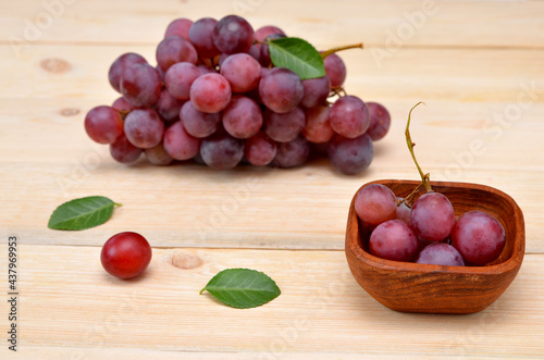 red grapes in a wooden bowl on the table