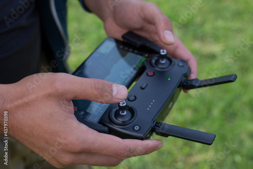 Male hands holding generic design dron remote controller doing