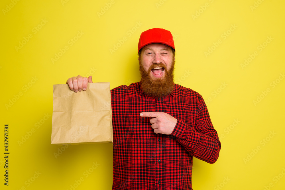 Delivery man with hat and beard has an happy expression Delivery man with hat and beard has an happy expression