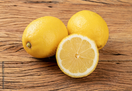 Sicilian lemons and half fruit over wooden table