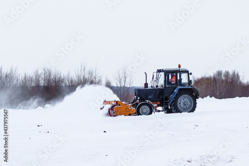 Road workers clear a highway after a heavy snowfall