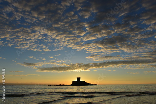 St Ouen;s Bay, Jersey, U.K. Spring coastal sunset with 19th century island military Rocco tower.