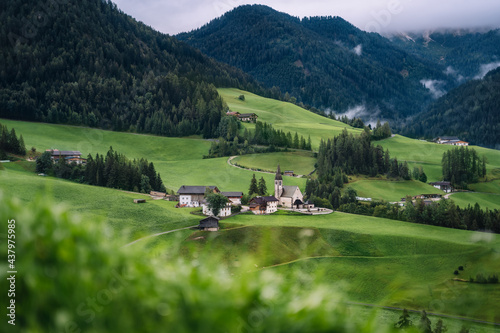 St Magdalena church in Val di Funes valley  Dolomites  Italy. Furchetta and Sass Rigais mountain peaks in background