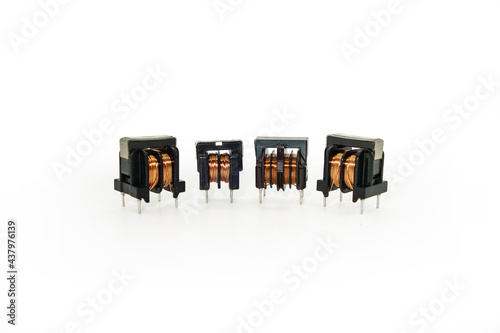 Ferrite core inductors with two windings, arranged in line. White background