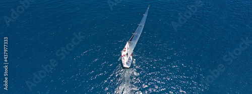 Aerial drone top down ultra wide photo of luxury sail boat cruising in the Aegean deep blue sea © aerial-drone