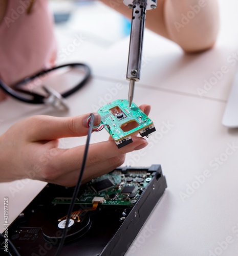 Engineer fixing broken computer hard drive