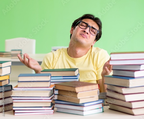 Student with too many books to read before exam