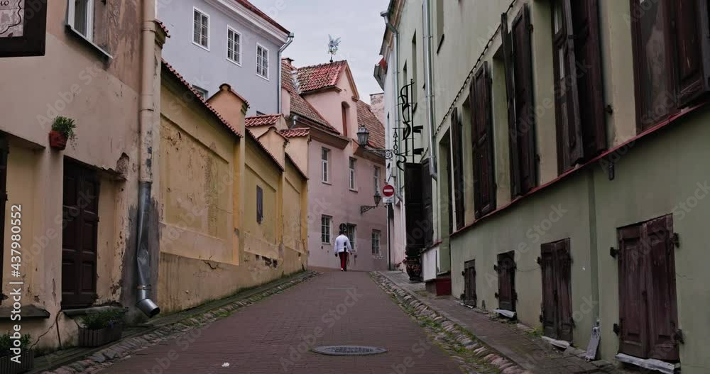Tourist walking in European old town on a beautiful warm day. Historic city architecture, cozy beautiful narrow street view. Vacation, traveling in Europa after lockdown, end of quarantine. 4K footage Tourist walking in European old town on a beautiful warm day. Historic city architecture, cozy beautiful narrow street view. Vacation, traveling in Europa after lockdown, end of quarantine. 4K footage