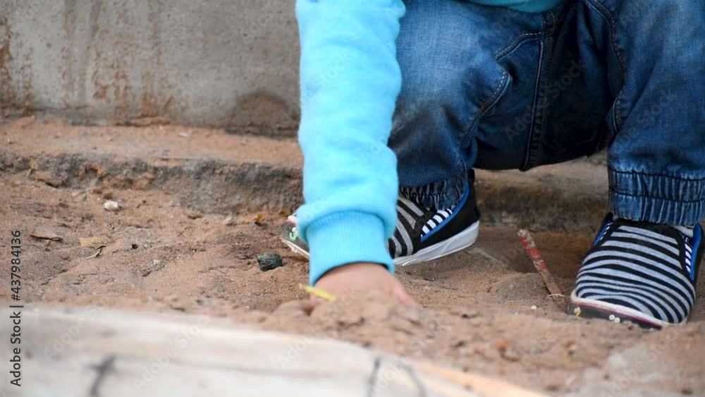 Small kid hands playing in sand on playground, Close Up Shot Of His Little Hands