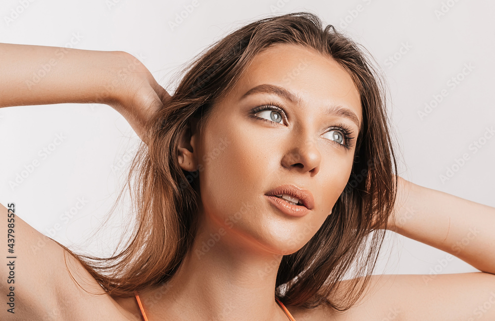 Beautiful young girl smiling and posing looking at the camera on a white isolated background. Positive brunette woman. Kind look. Beauty face Beautiful young girl smiling and posing looking at the camera on a white isolated background. Positive brunette woman. Kind look. Beauty face