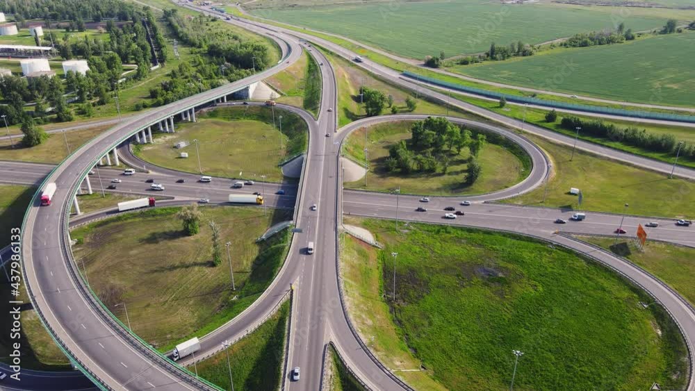 Aerial drone view of highway multi-level junction road with moving cars. Cars are moving on a multi-level road junction The concept of the urban
